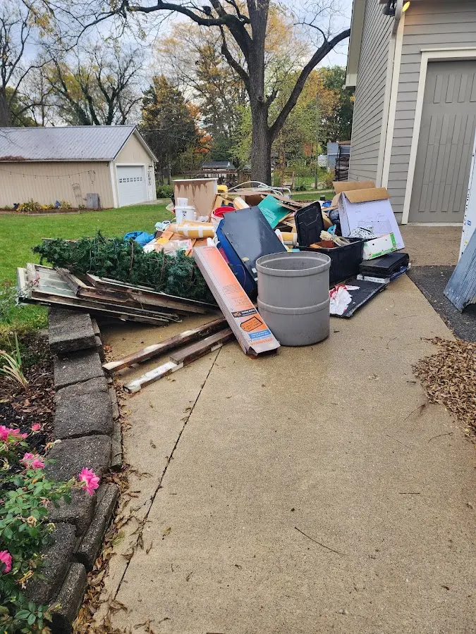 Dumpster being loaded with debris for Estate Cleanout Dumpster Rental in Acton